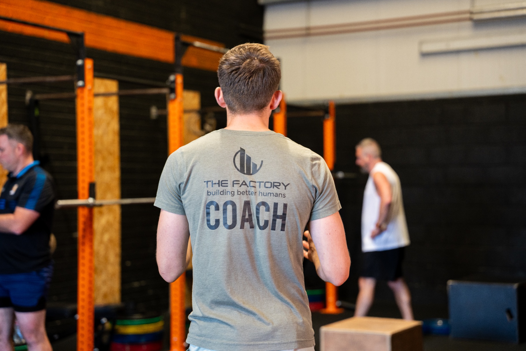 Coach in branded t-shirt at The Factory gym