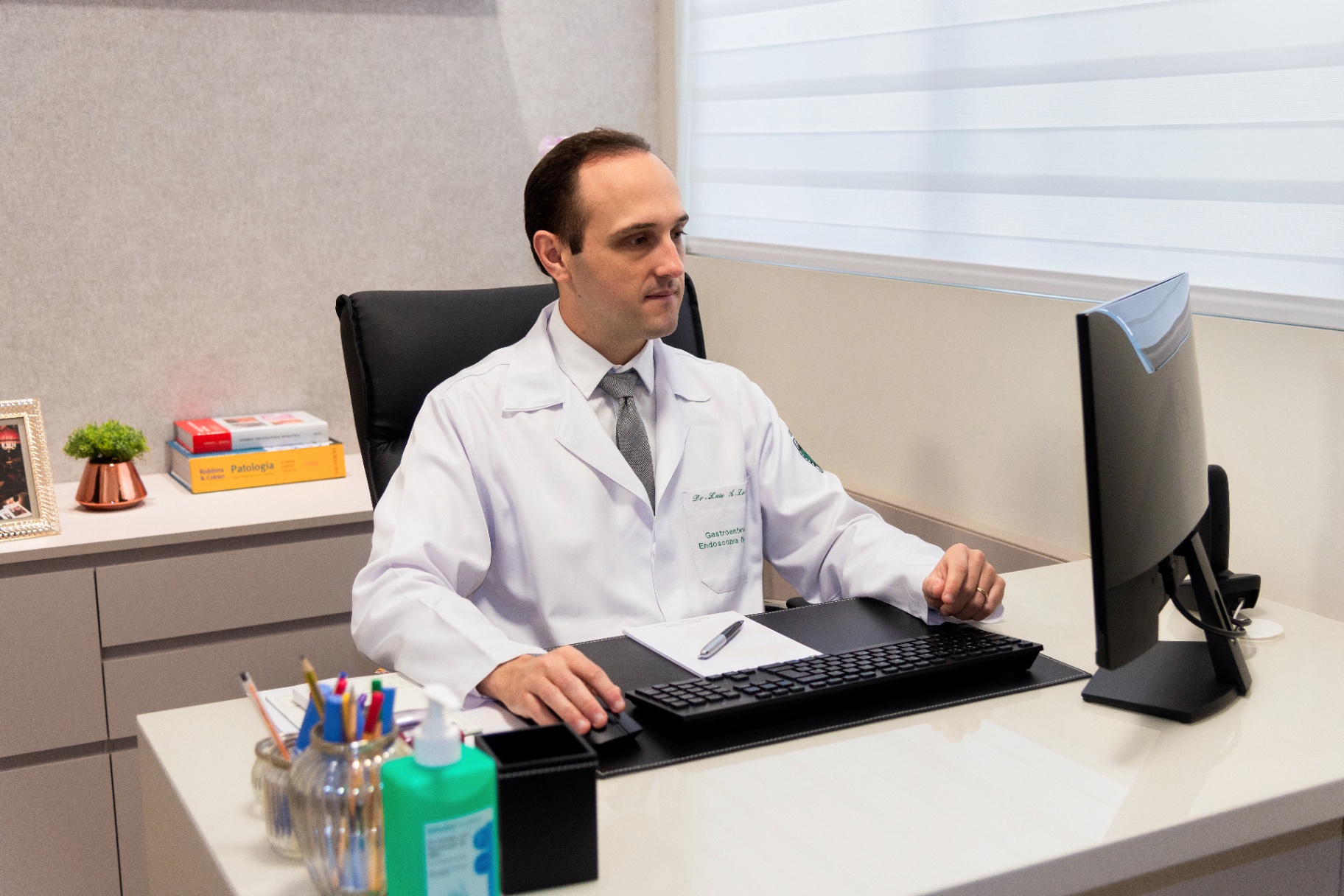 Doctor working at his desk in a modern medical office