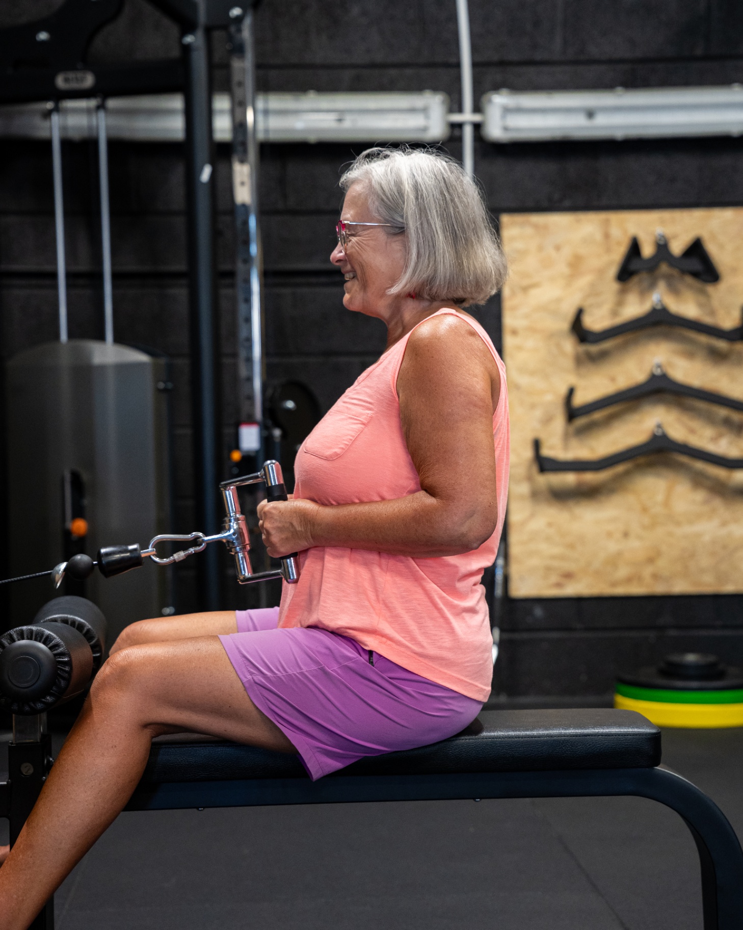 Client smiling during a seated row training