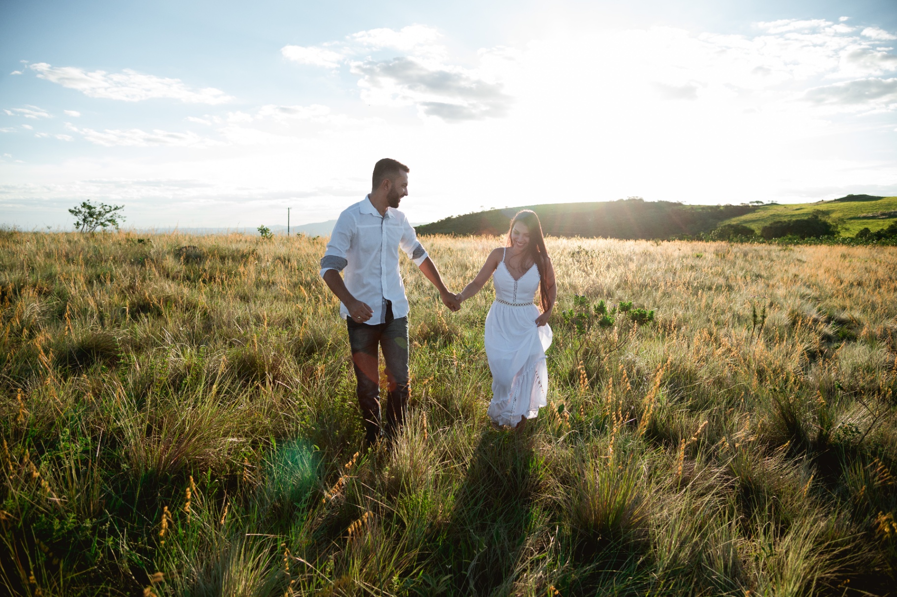 Couple holding hands in a field