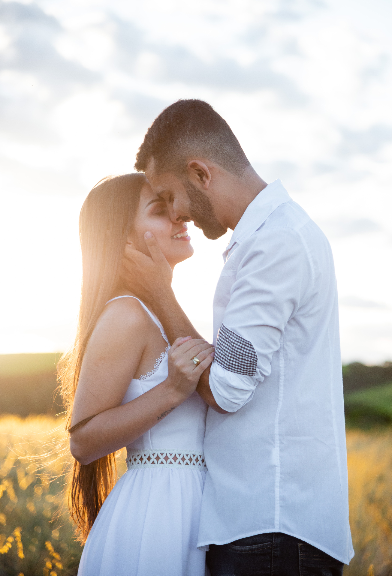 Couple in a tender embrace at sunset
