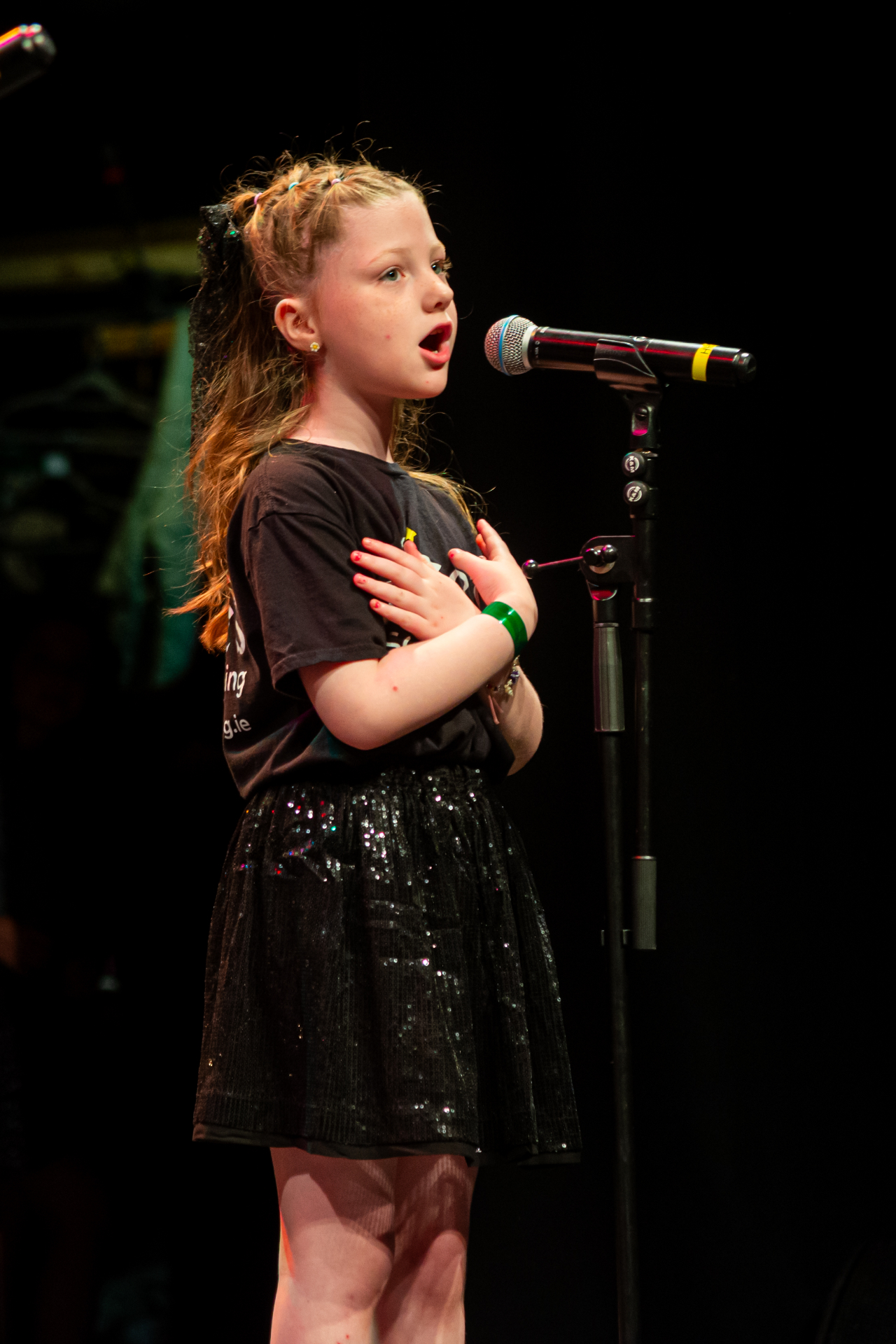Young singer performing solo at the microphone
