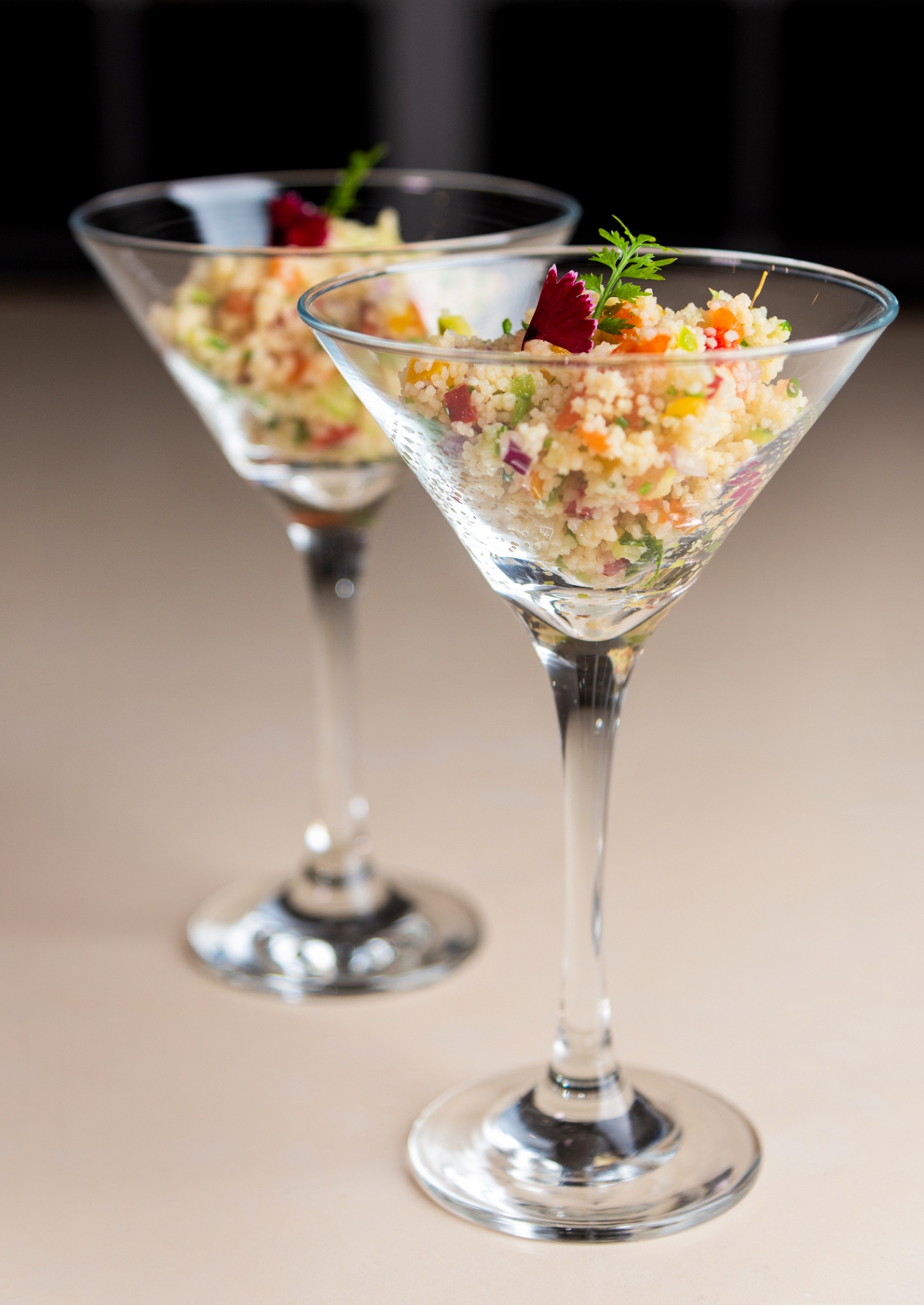 Colorful couscous salad served in elegant martini glasses