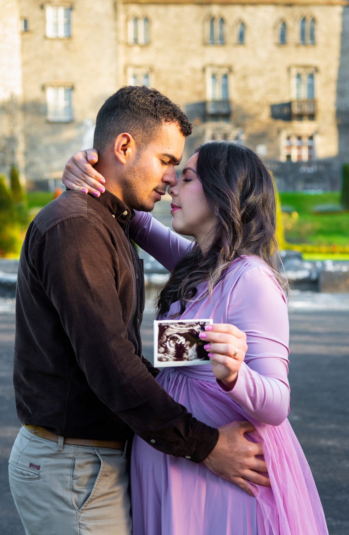 Couple holding an ultrasound photo during maternity session
