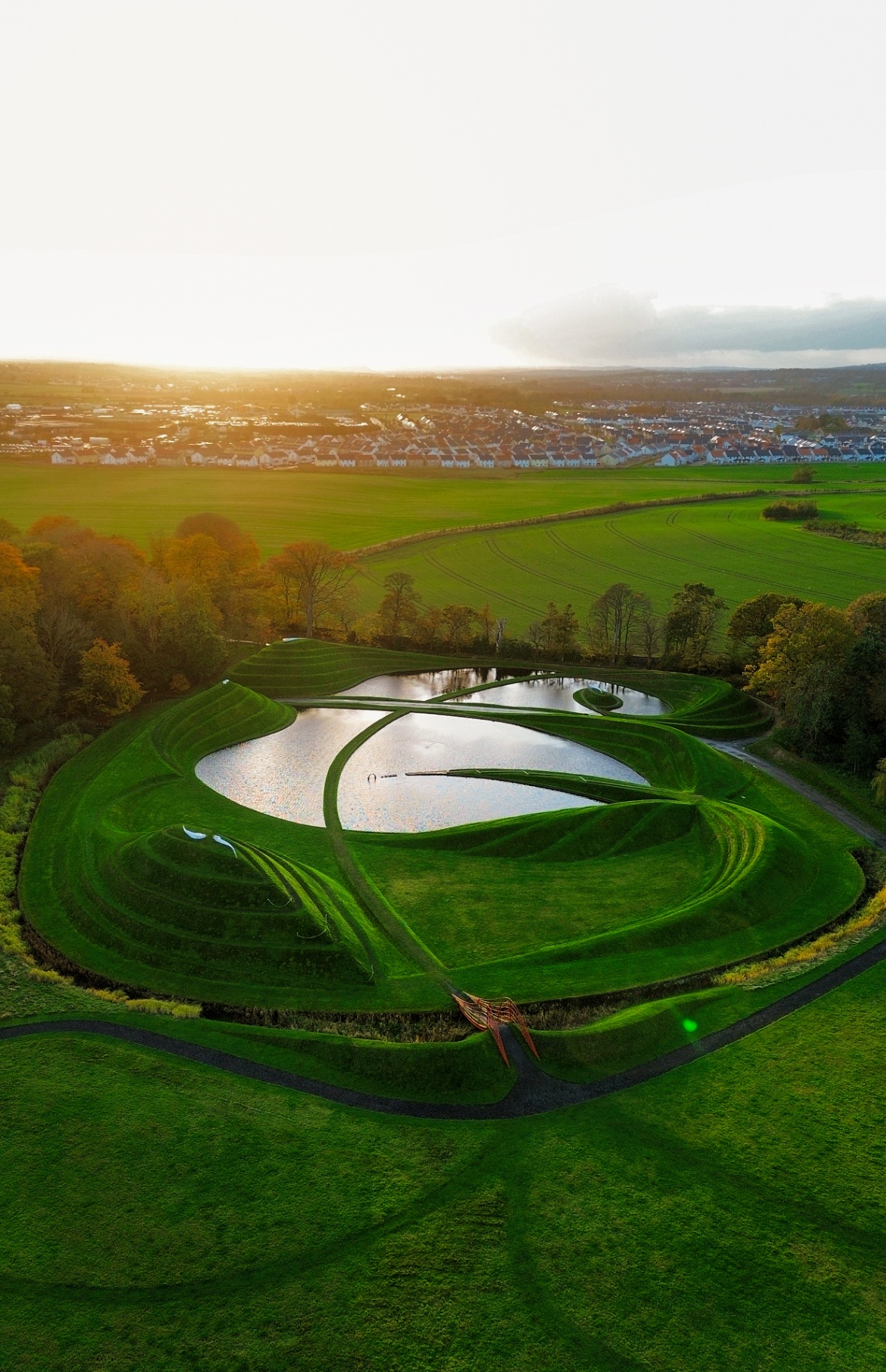 Landform sculpture pools at sunset from above