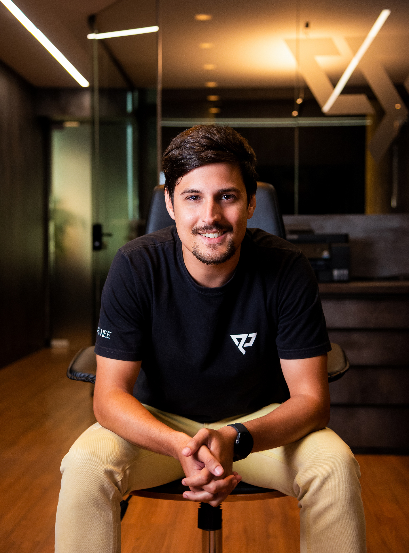 Friendly portrait of a man in a branded t-shirt in a studio